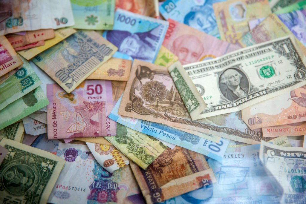 Collection of international currencies including USD, pesos, and other foreign banknotes Various international banknotes including U.S. dollars, pesos, rupees, and other foreign currencies scattered on a surface.